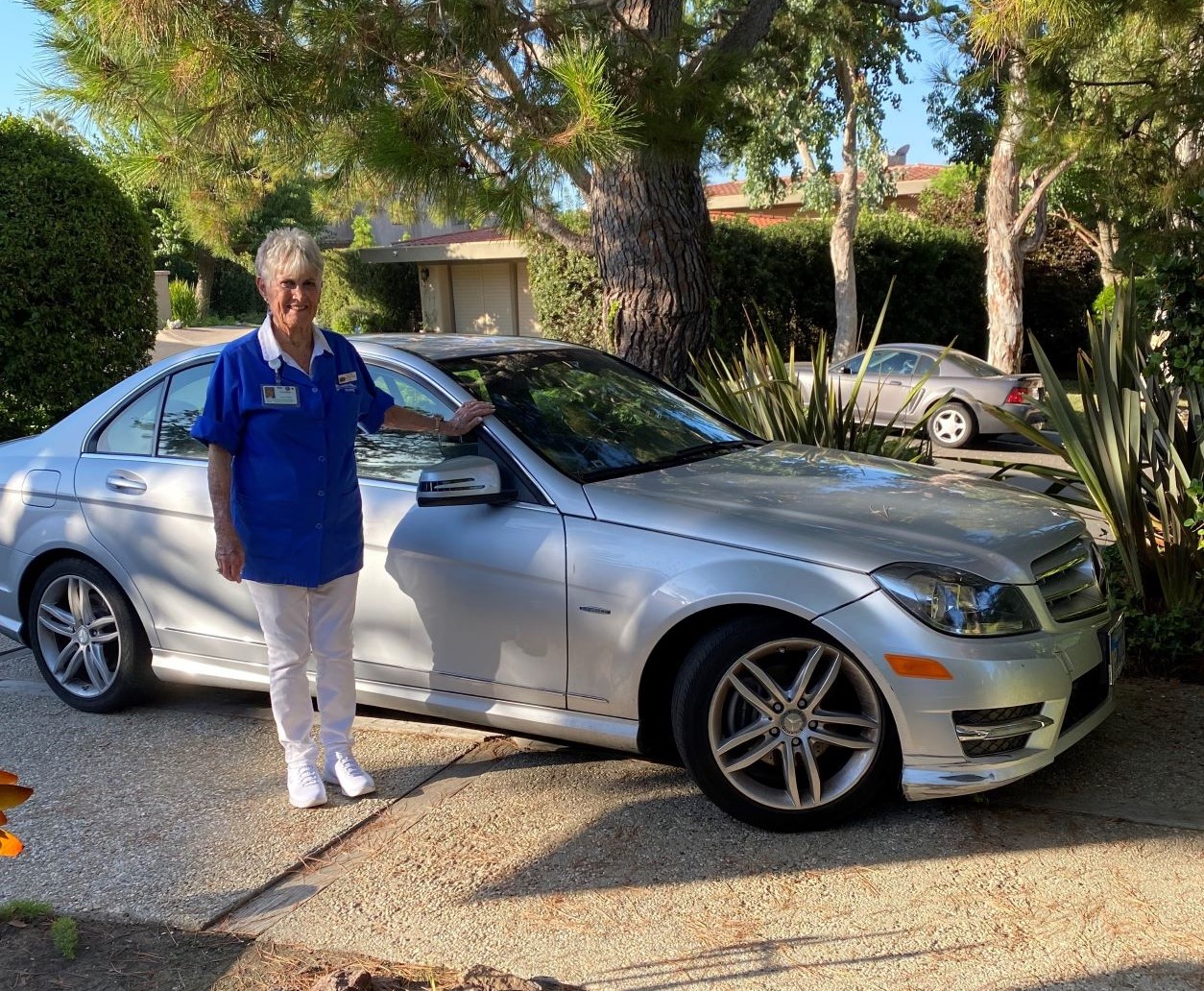 Laurie Anderson with car she donated to benefit Torrance Memorial