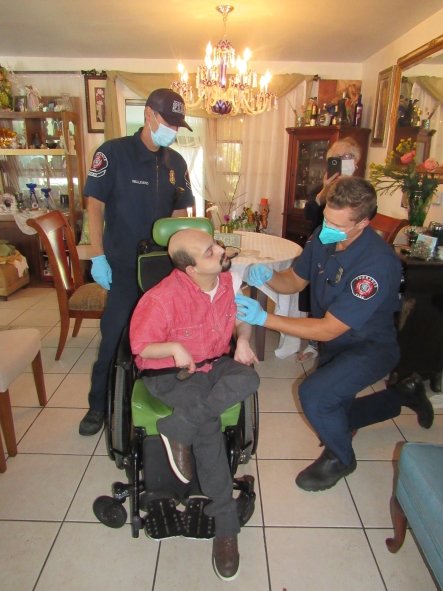 Alex Farah receive a COVID-19 vaccine from the Torrance Fire Department.