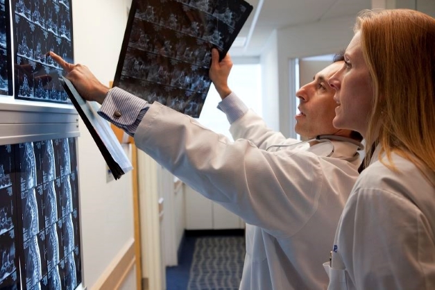 Torrance Memorial's Tumor Board doctors patient scan images.